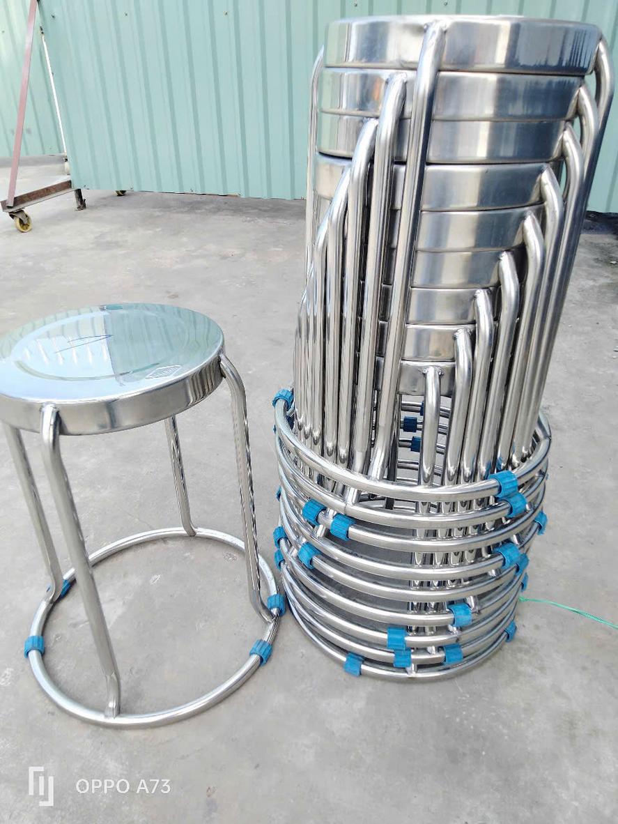 Kỹ thuật viên đang kiểm tra chất lượng mối hàn trên khung ghế inox.