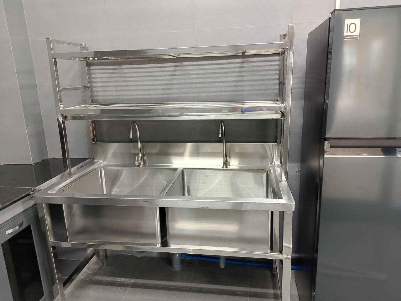 thi công bếp ăn công nghiệp công ty UNIND Bình Phước 2025 lắp đặt chậu rửa công nghiệp có kệ để chén dĩa